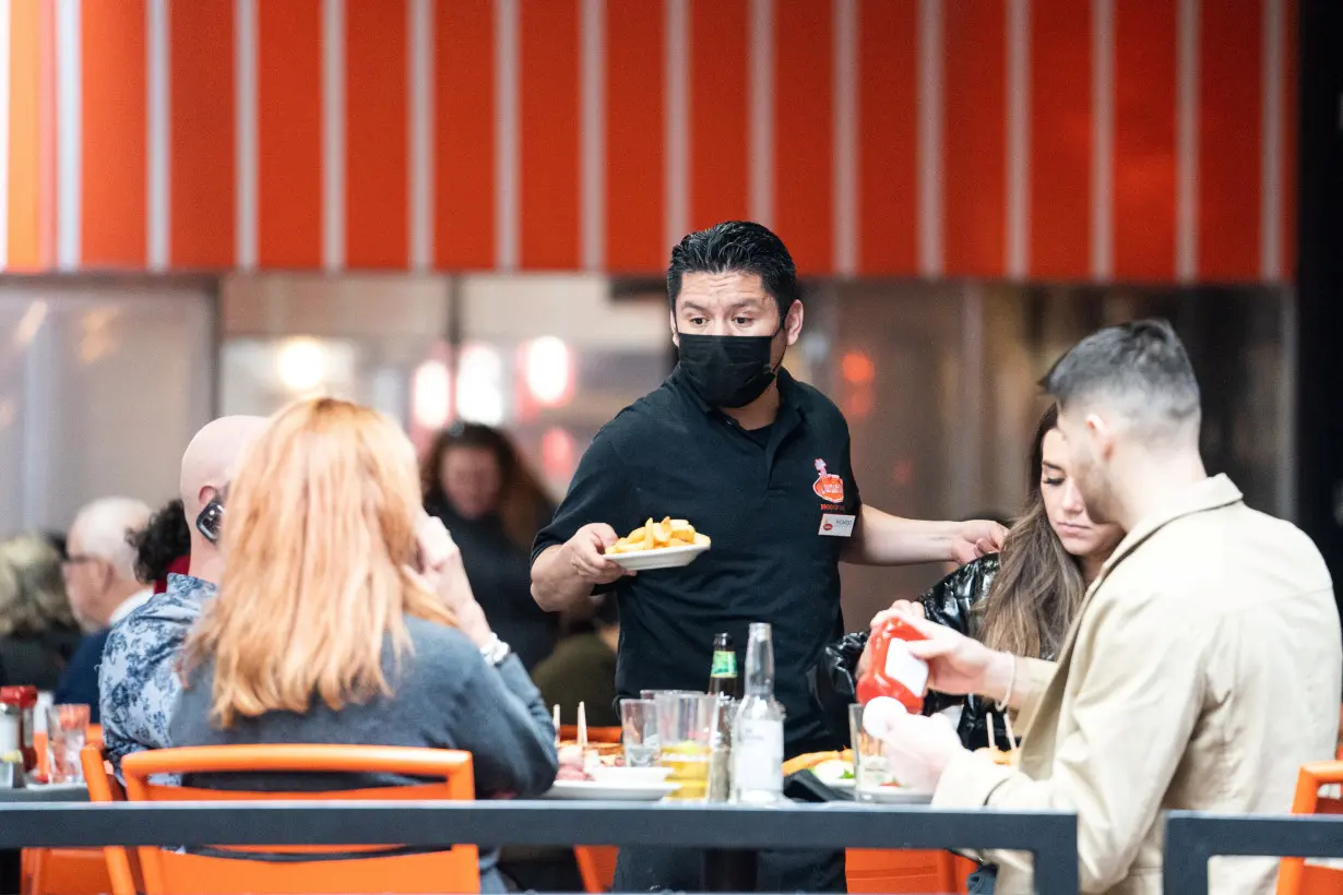 FILE PHOTO: A waiter serves food at a restaurant near Times Square in New York City