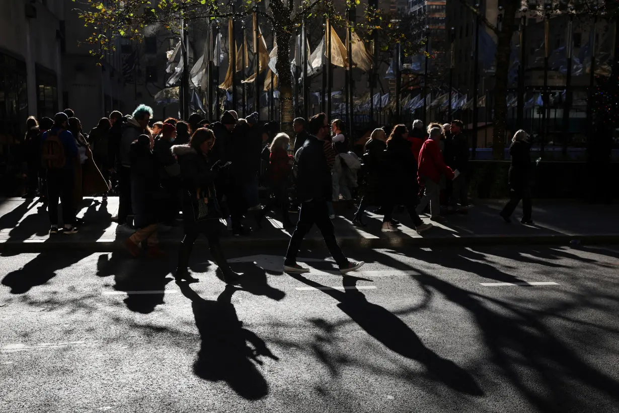 People walk near the Rockefeller Center Christmas Tree at Rockefeller Center in the Midtown area of New York City