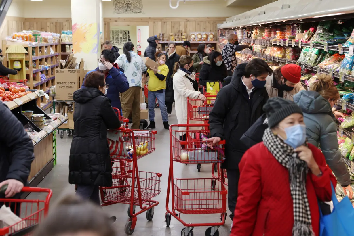 FILE PHOTO: People shop in a grocery store in Manhattan, New York City
