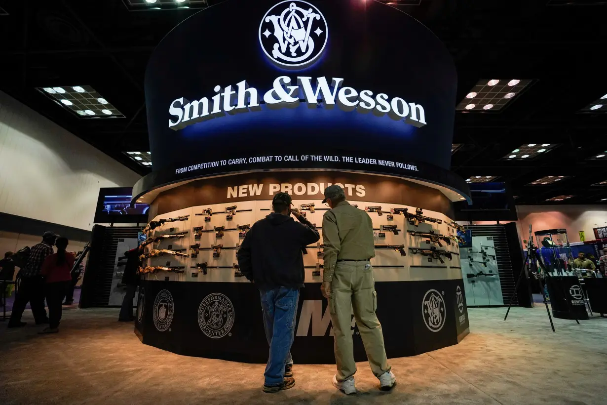 FILE PHOTO: Attendees inspect Smith and Wesson rifles at the National Rifle Association's (NRA) annual meeting, in Indianapolis, Indiana