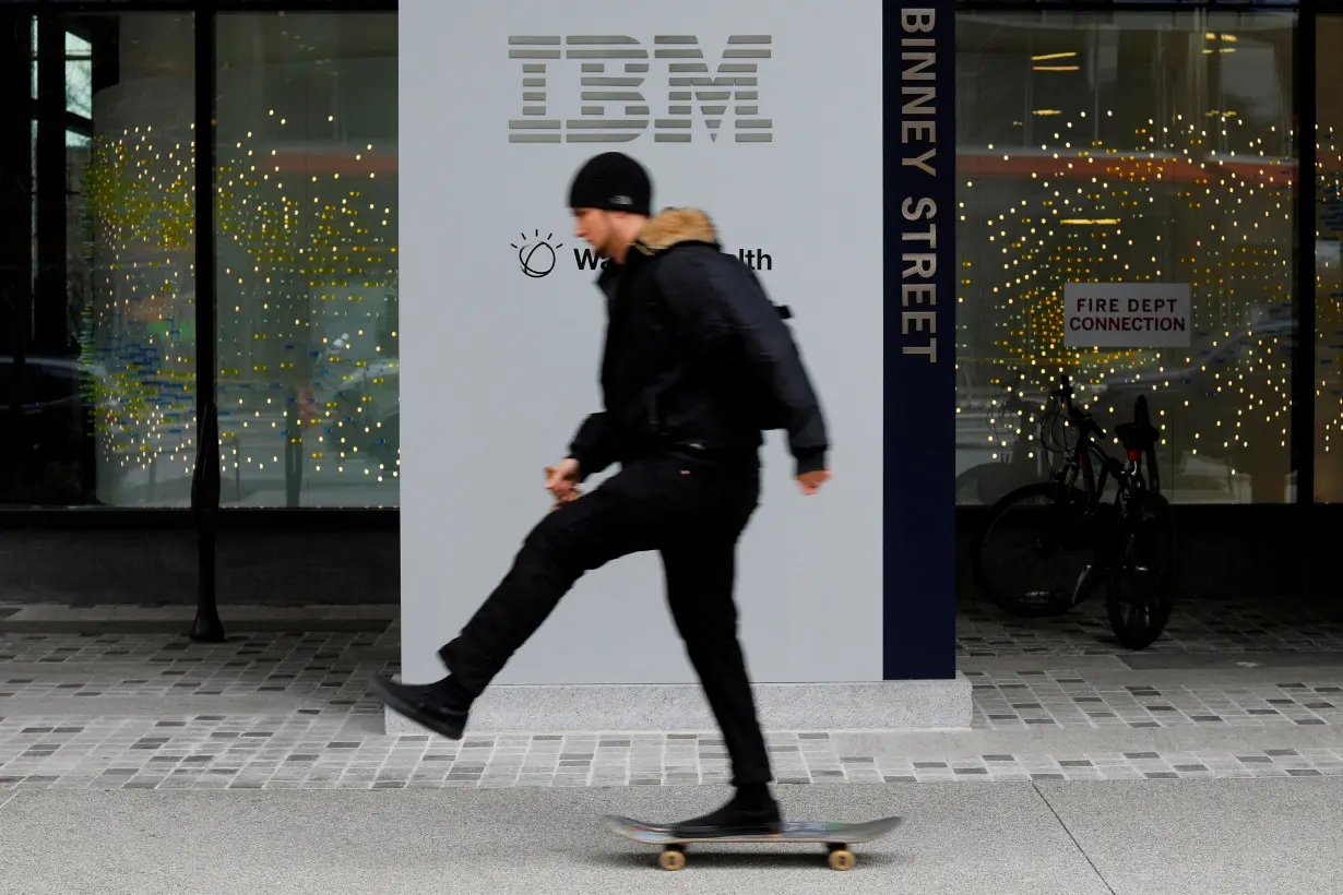 FILE PHOTO: A skateboarder passes the sign for an IBM office in Cambridge