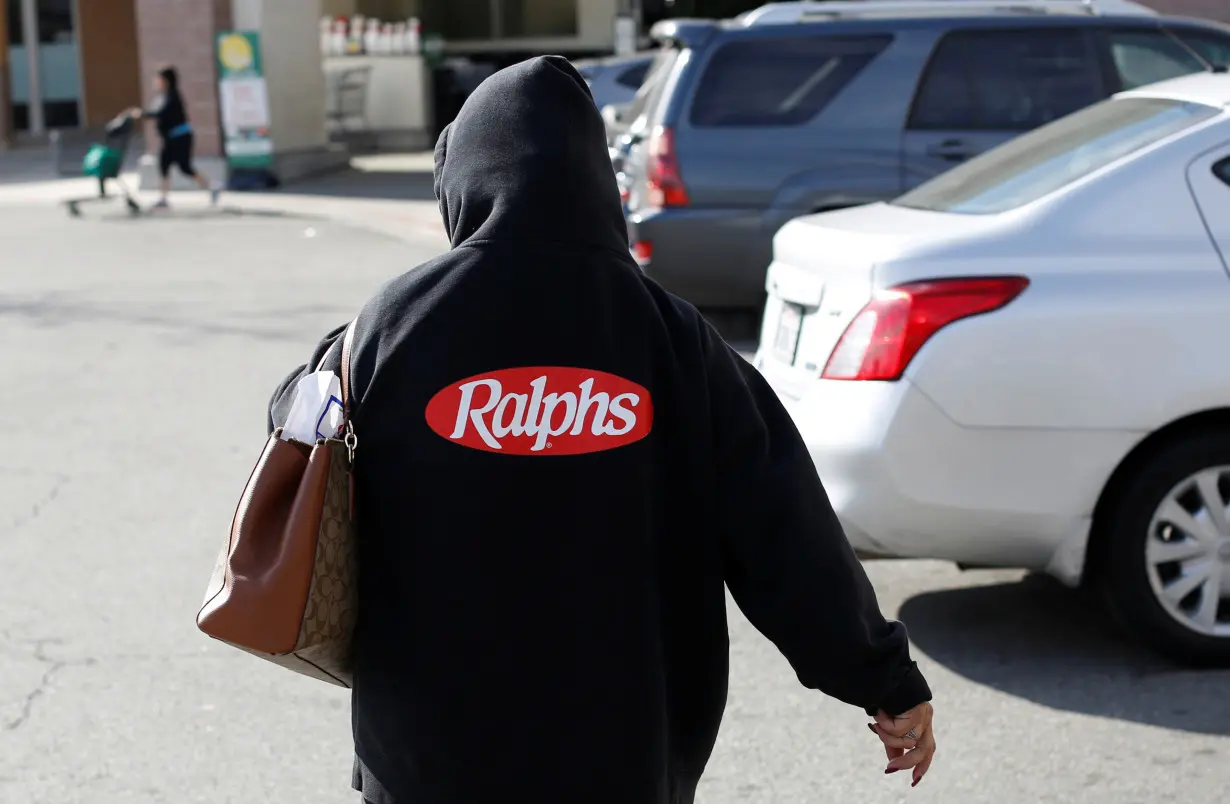 An employee walks back towards a Ralphs grocery store, which is owned by Kroger Co, ahead of company results in Pasadena