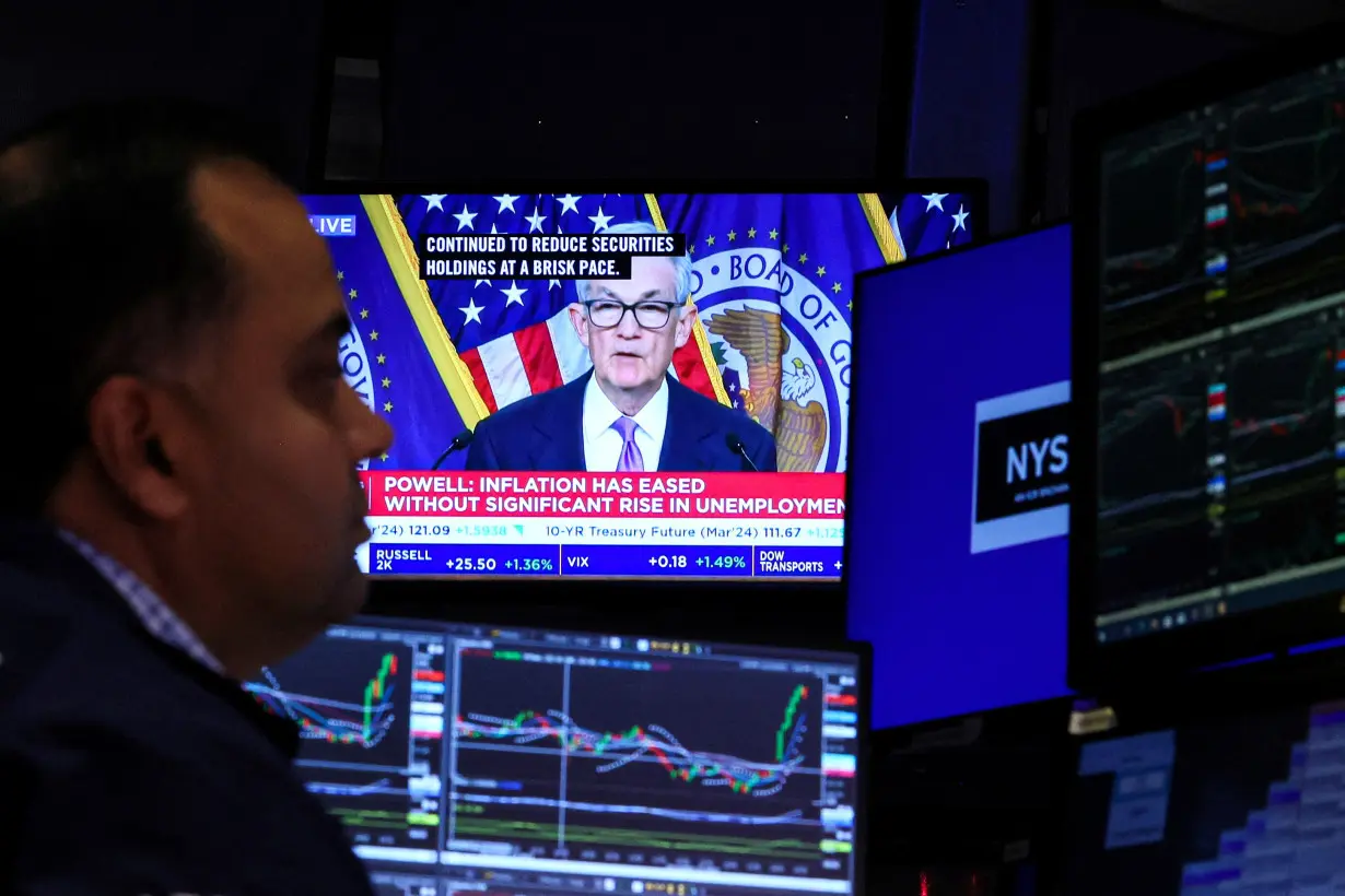 FILE PHOTO: Traders react to Fed rate announcement on the floor of the NYSE in New York