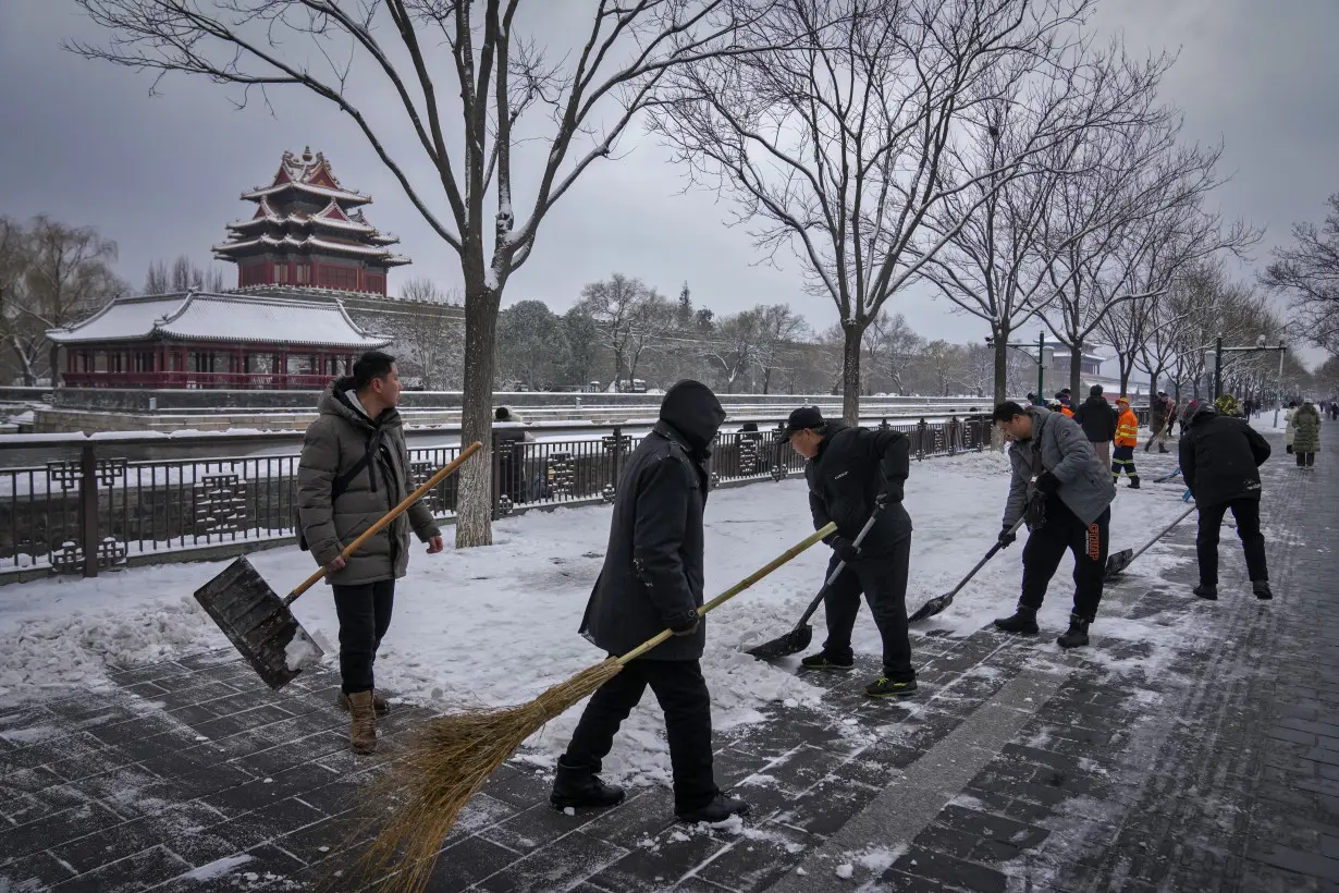 Snow blankets northern China, closing roads and schools and suspending train service