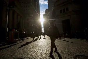 FILE PHOTO: Morning commuters walk on Wall Street in New York's financial district
