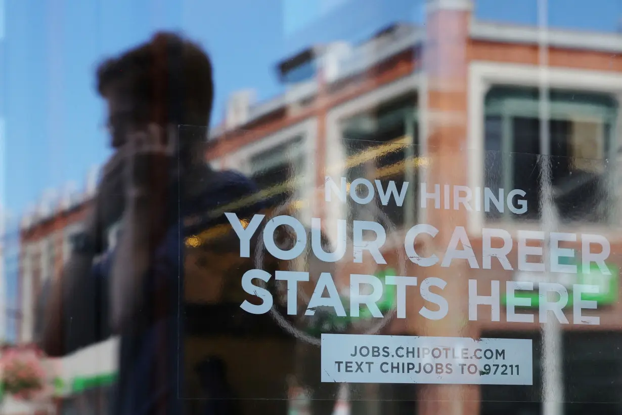 A Chipotle restaurant advertises it is hiring in Cambridge, MA