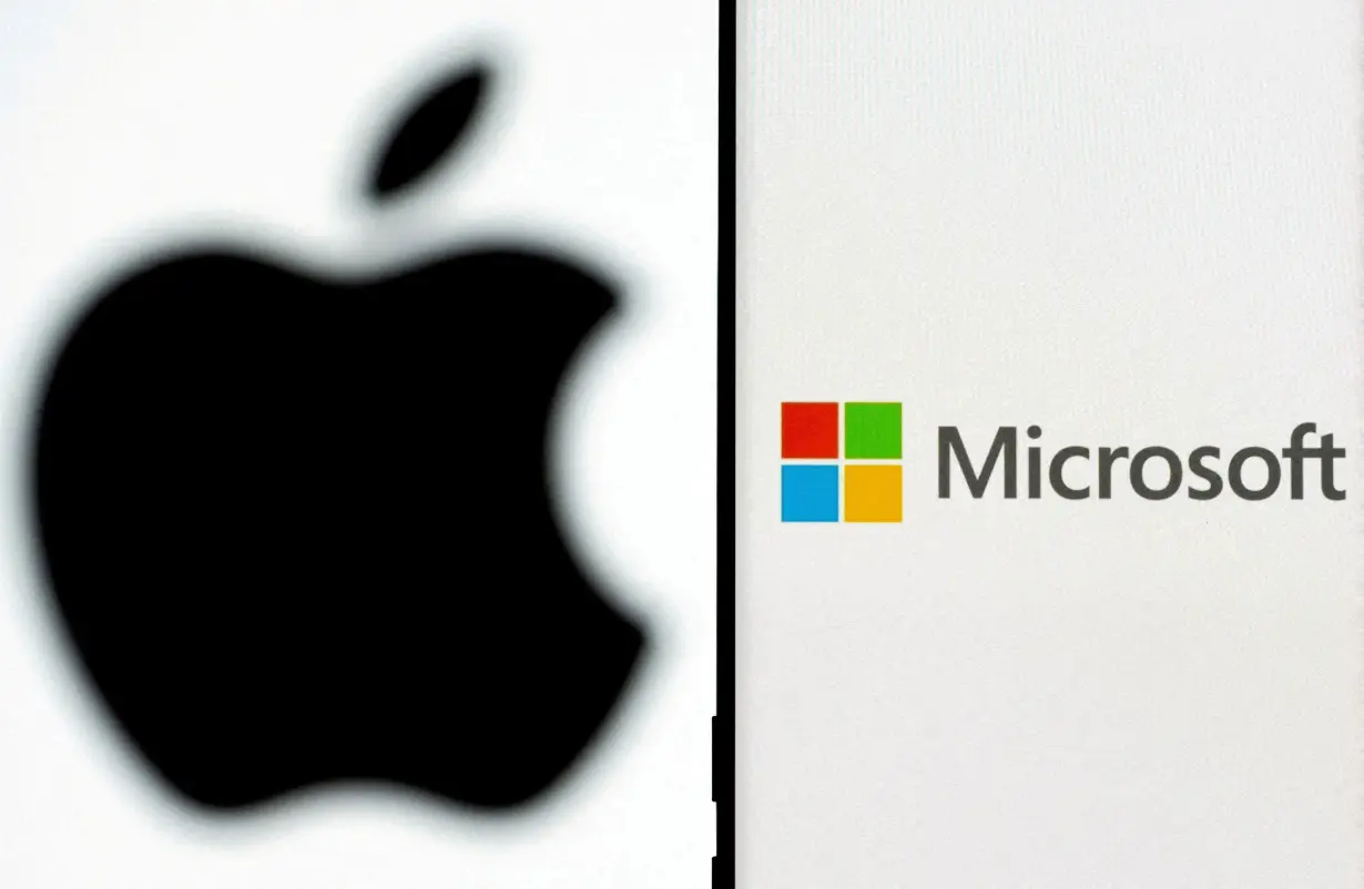 FILE PHOTO: Microsoft logo is seen on the smartphone in front of displayed Apple logo in this illustration