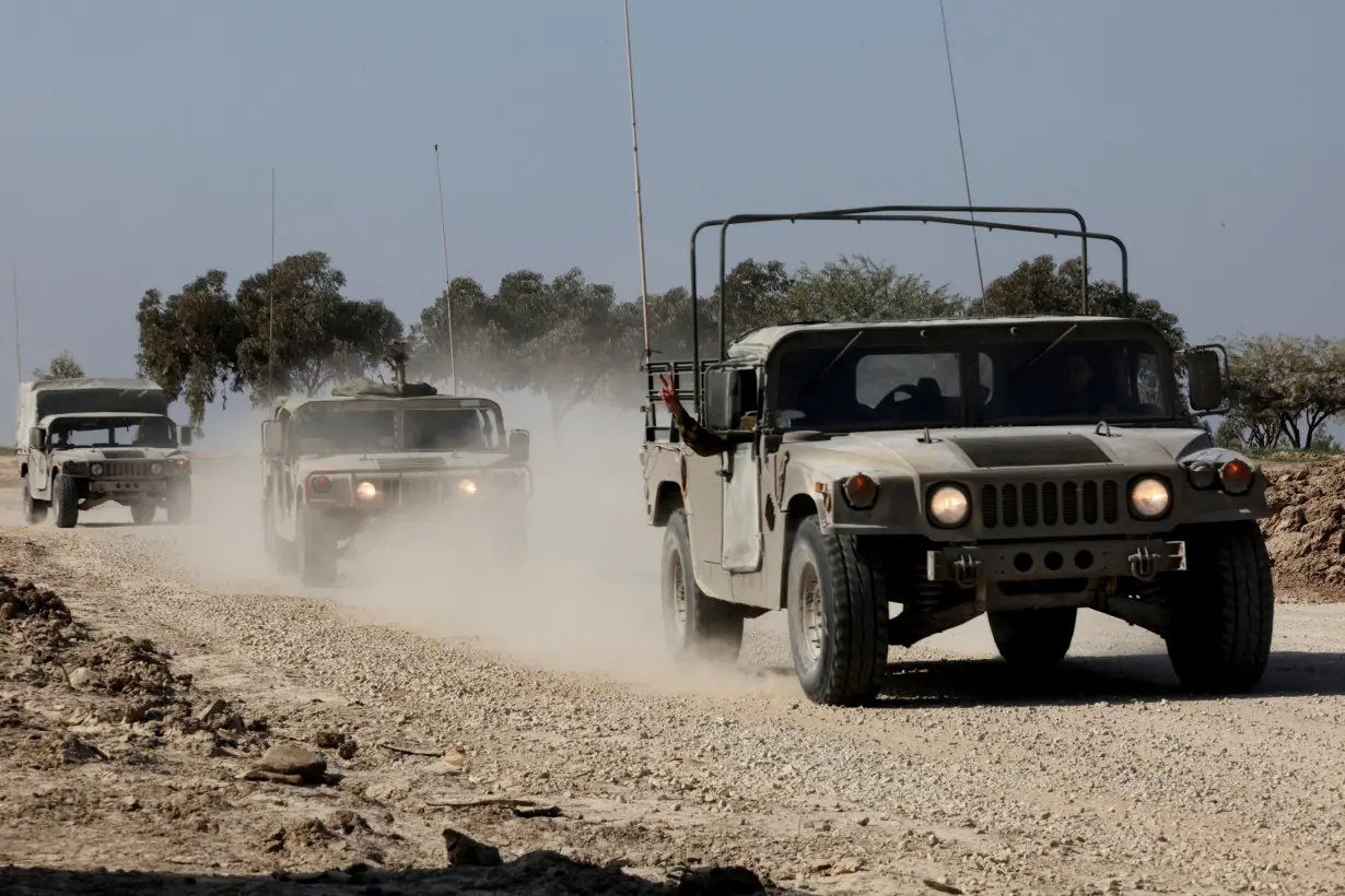 FILE PHOTO: Israeli military vehicles move near the Israel-Gaza border