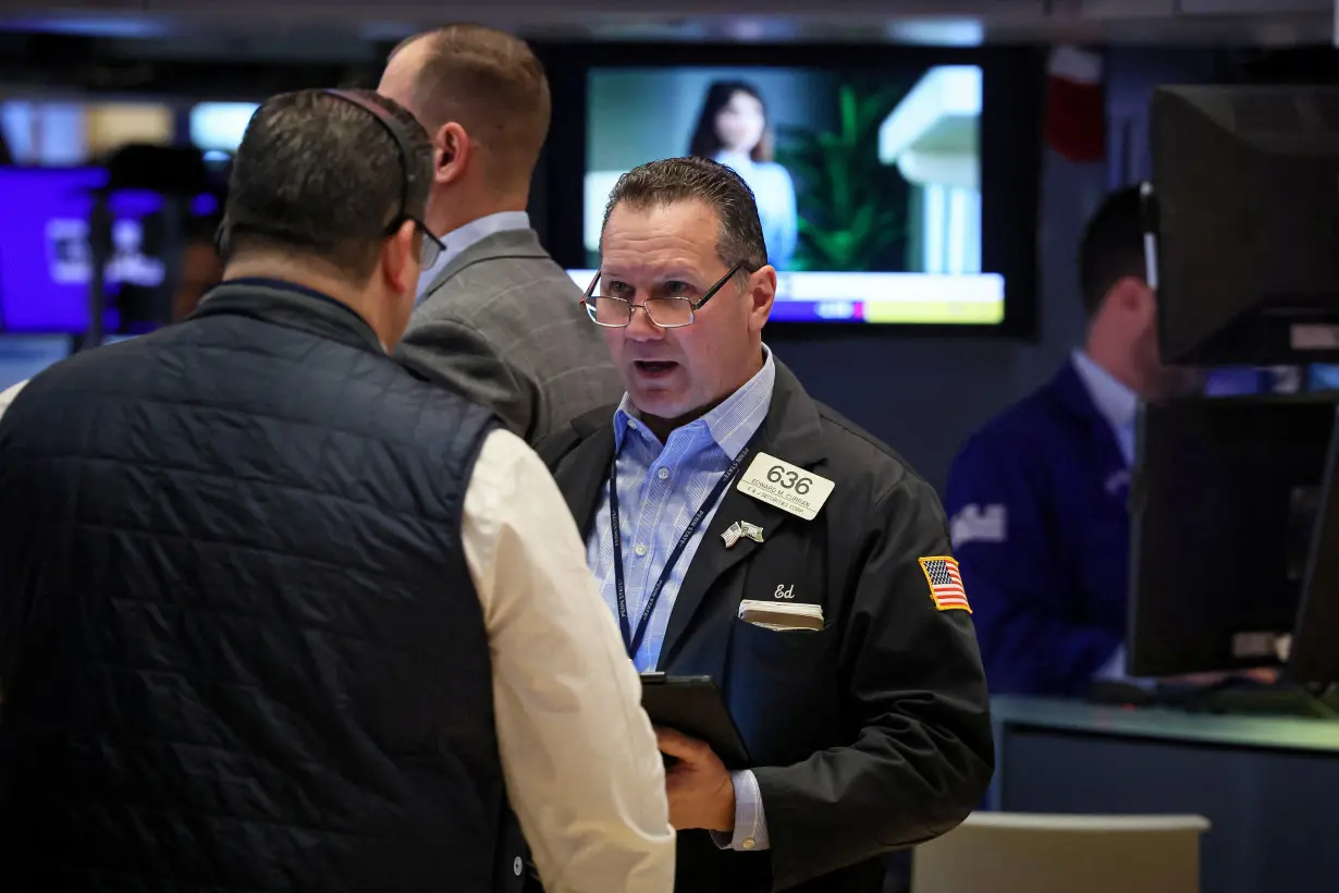 Traders work on the floor of the NYSE in New York