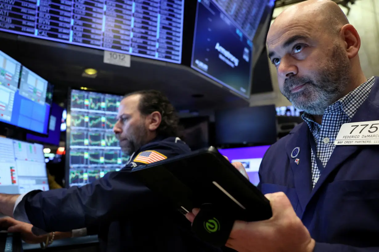 Traders work on the floor of the NYSE in New York