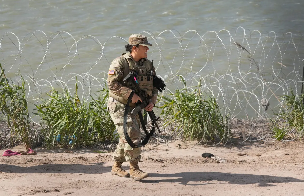 An Army National Guard soldier patrols the banks of the Rio Grande