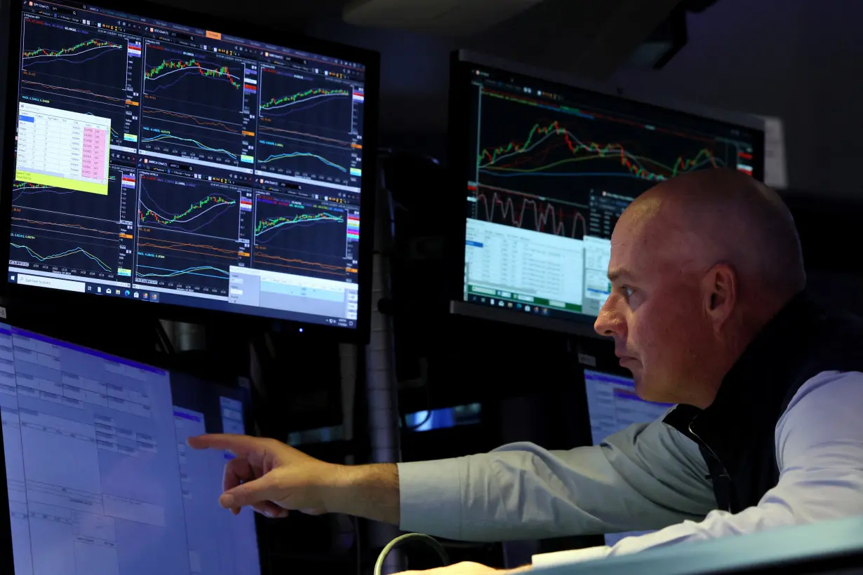 Traders work on the floor of the NYSE in New York