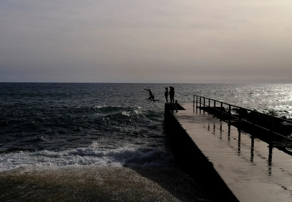 Pierre from Belgium, jumps into the Atlantic Ocean at Jardim do Mar on the Portuguese island of Madeira