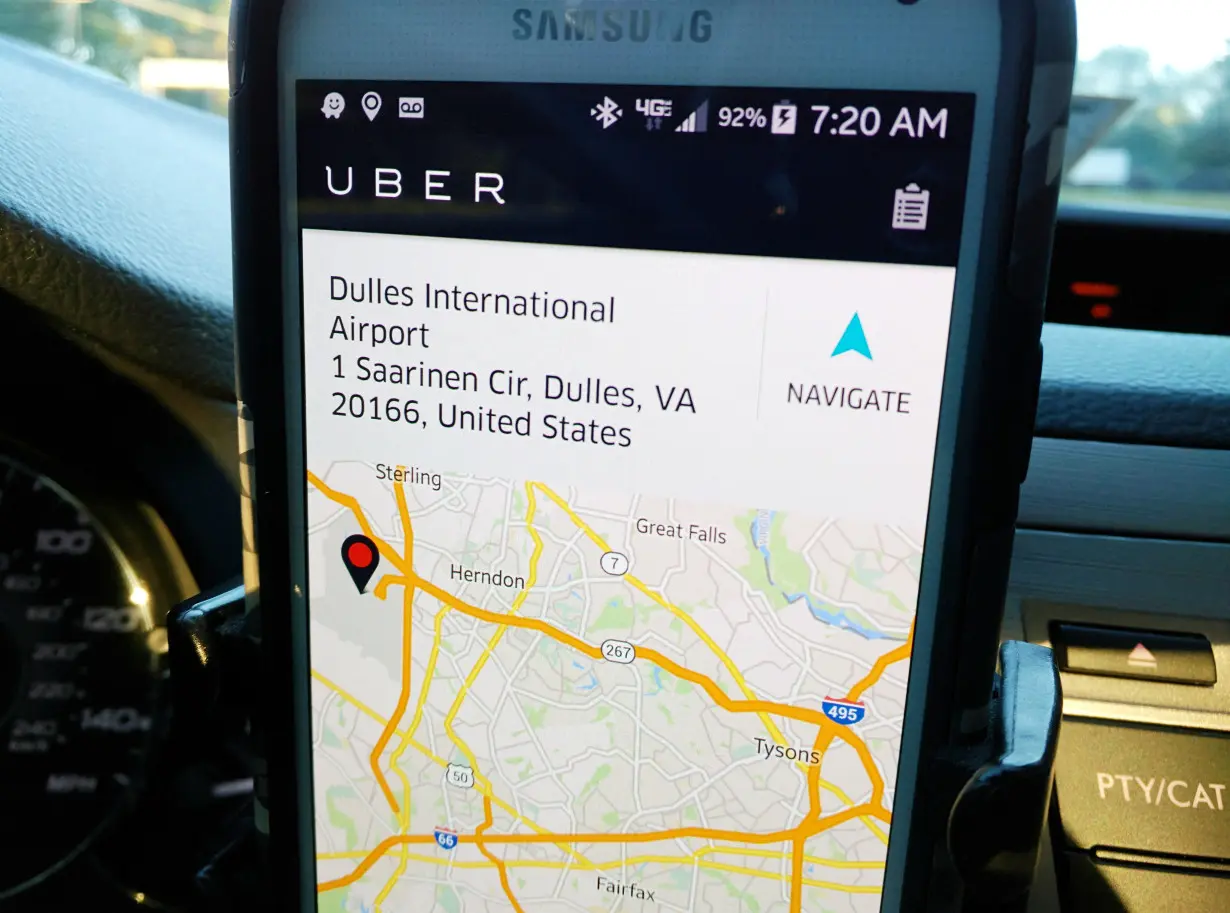 FILE PHOTO: An Uber driver's smartphone app en route to Washington Dulles International Airport