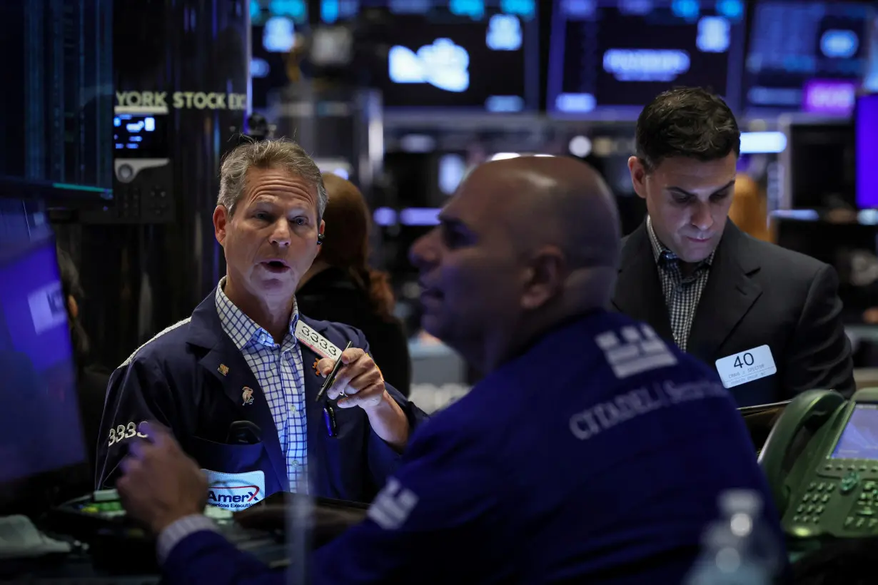 Traders work on the floor of the NYSE in New York