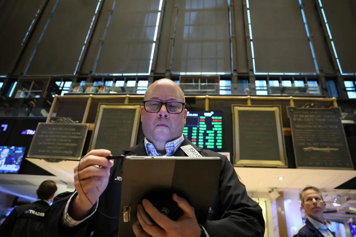 Traders work on the floor of the NYSE in New York