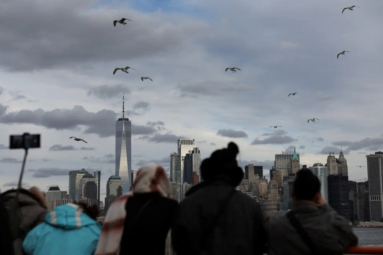 One World Trader Center stands in Lower Manhattan as people watch aboard the Staten Island Ferry in New York City