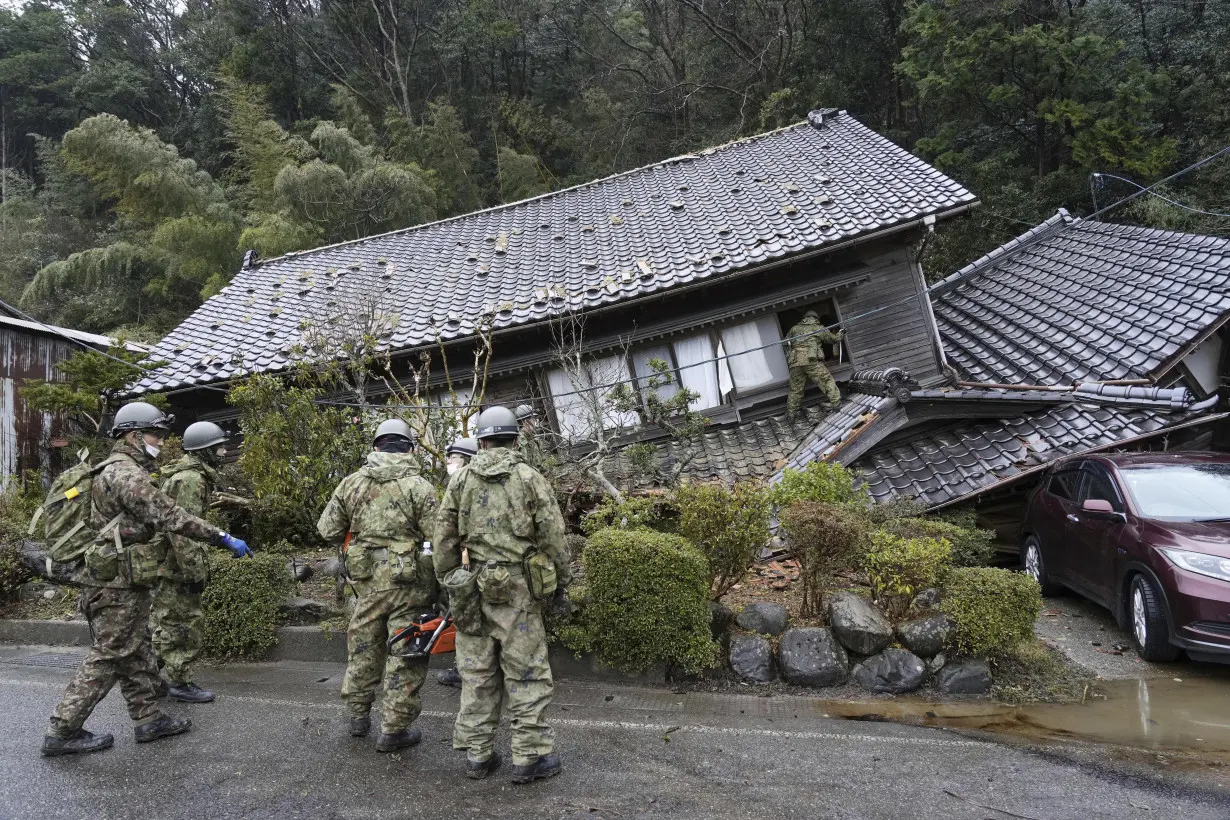 Rescuers race against time in search for survivors in Japan after powerful quakes leave 78 dead