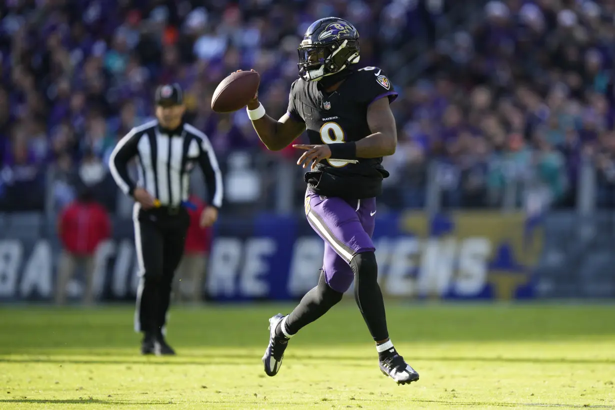 Lamar Jackson's perfect passer rating helps Ravens rout Dolphins 56-19 to clinch top seed in AFC