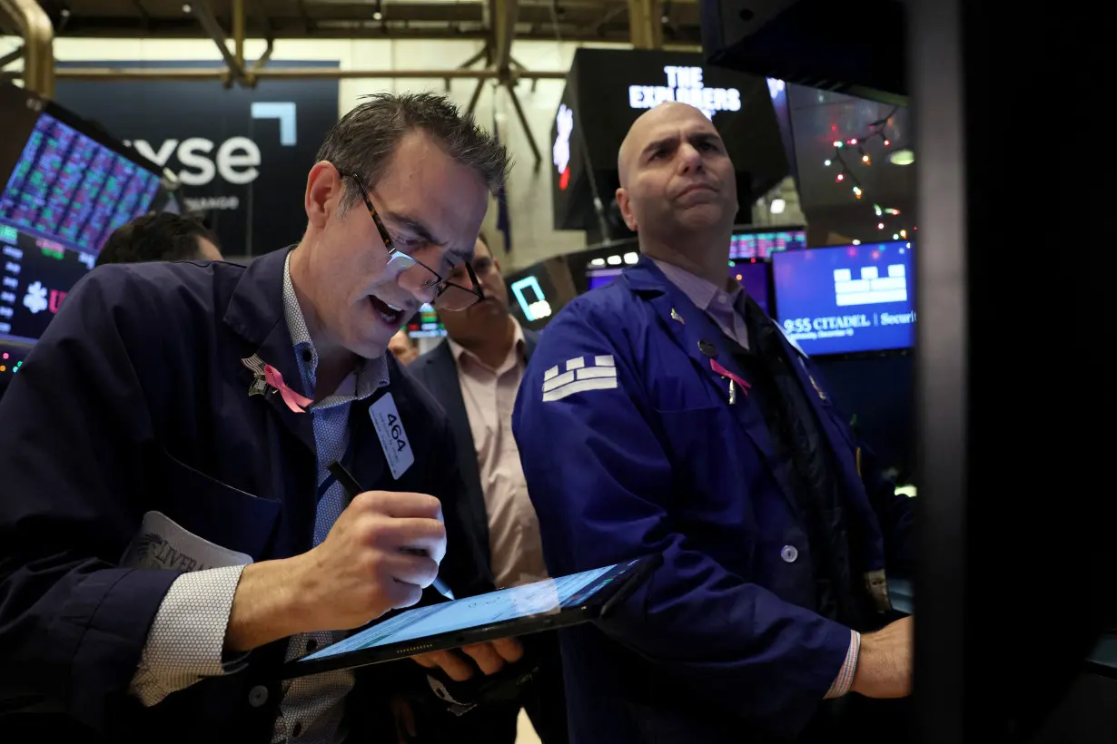 Traders work on the floor of the NYSE in New York