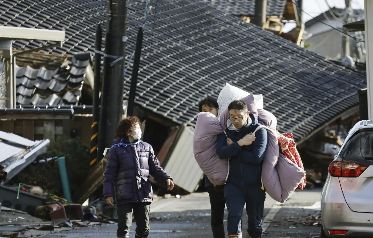 Rescuers race against time in search for survivors in Japan after powerful quakes leave 78 dead