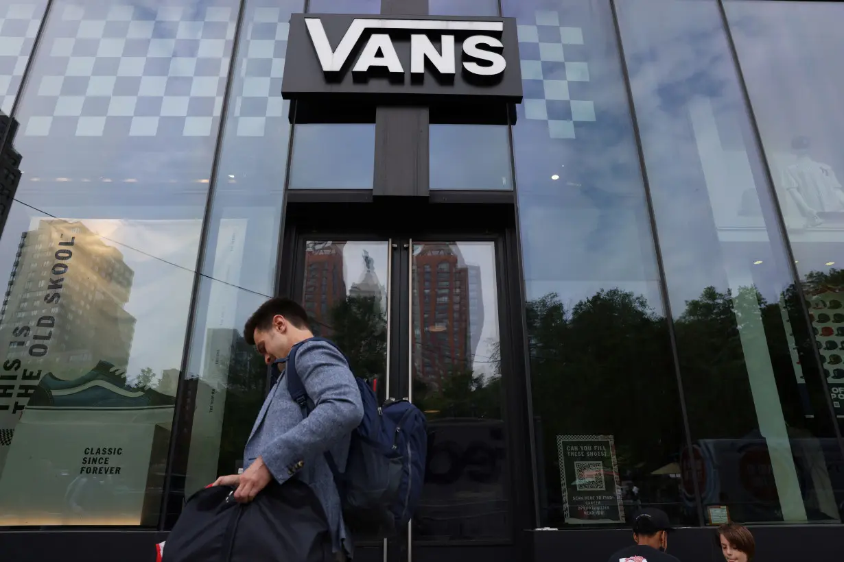 A person walks by a Vans store, a brand owned by VF Corporation, in Manhattan, New York City