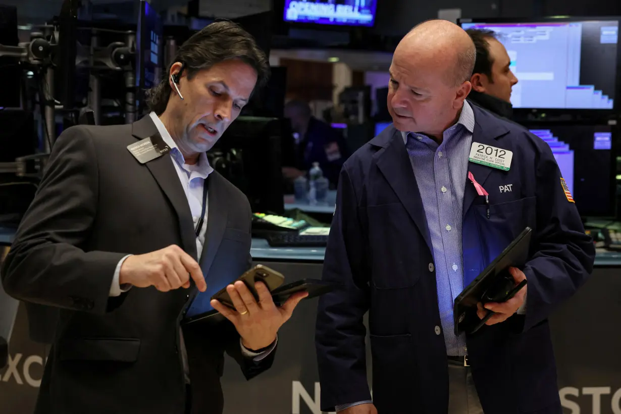 Traders work on the floor of the NYSE in New York