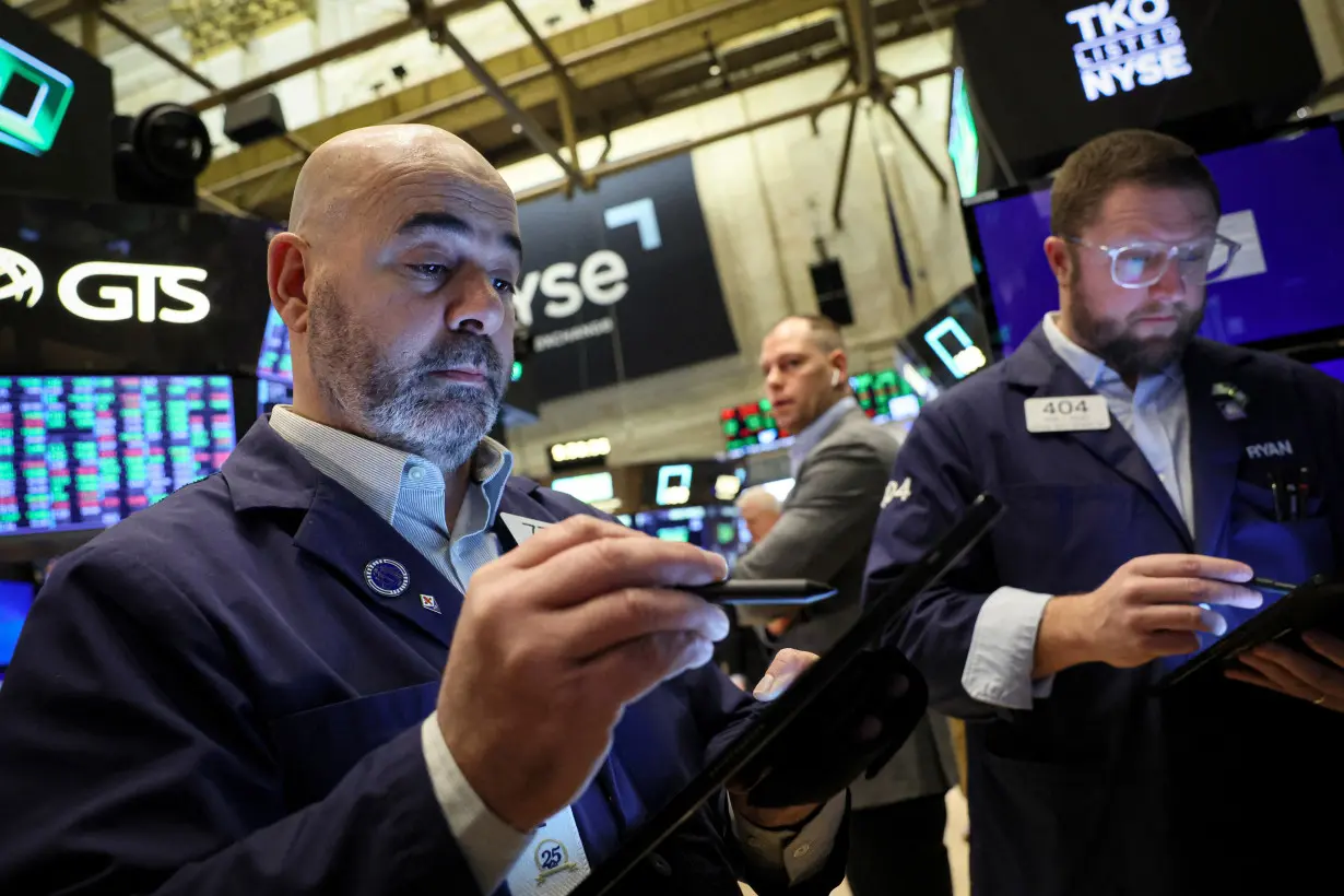 Traders work on the floor of the NYSE in New York