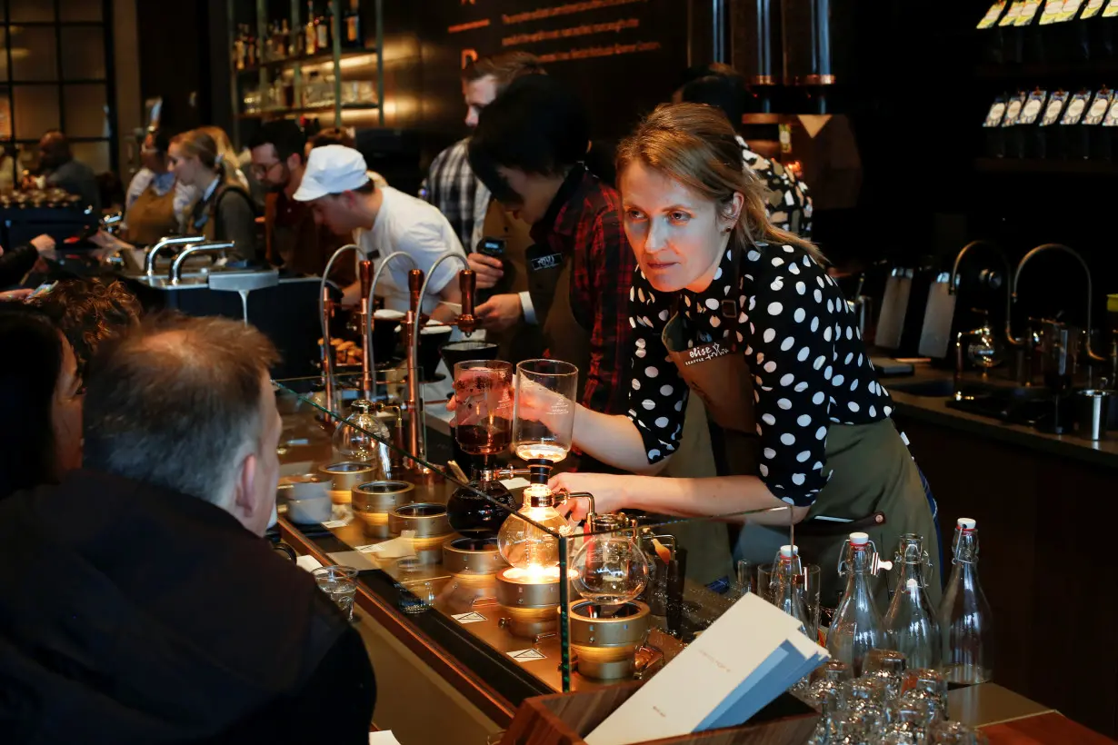 A barista prepares coffee using a siphon brewing method as Starbucks Corp opens the first upscale Starbucks Reserve store at the Starbucks headquarters in Seattle