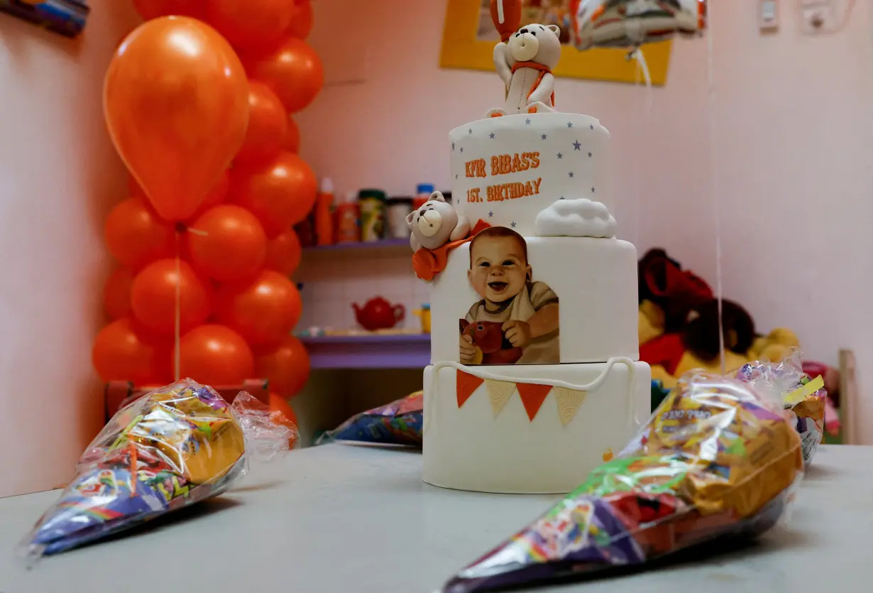 A birthday cake for Kfir Bibas is set up to call for his release, in Kibbutz Nir Oz