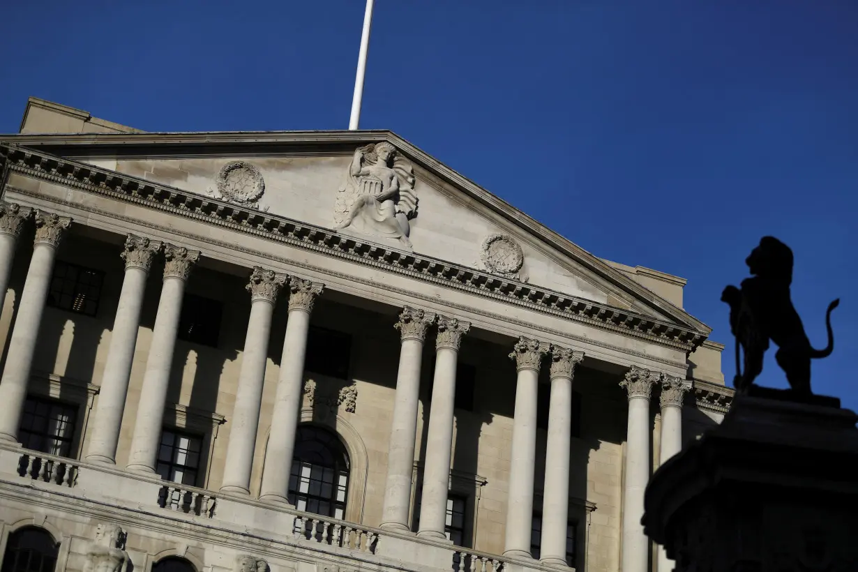 FILE PHOTO: A statue is silhouetted against the Bank of England in the City of London