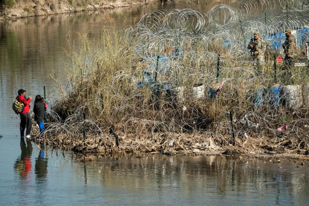 Migrants cross the border into Texas from Mexico