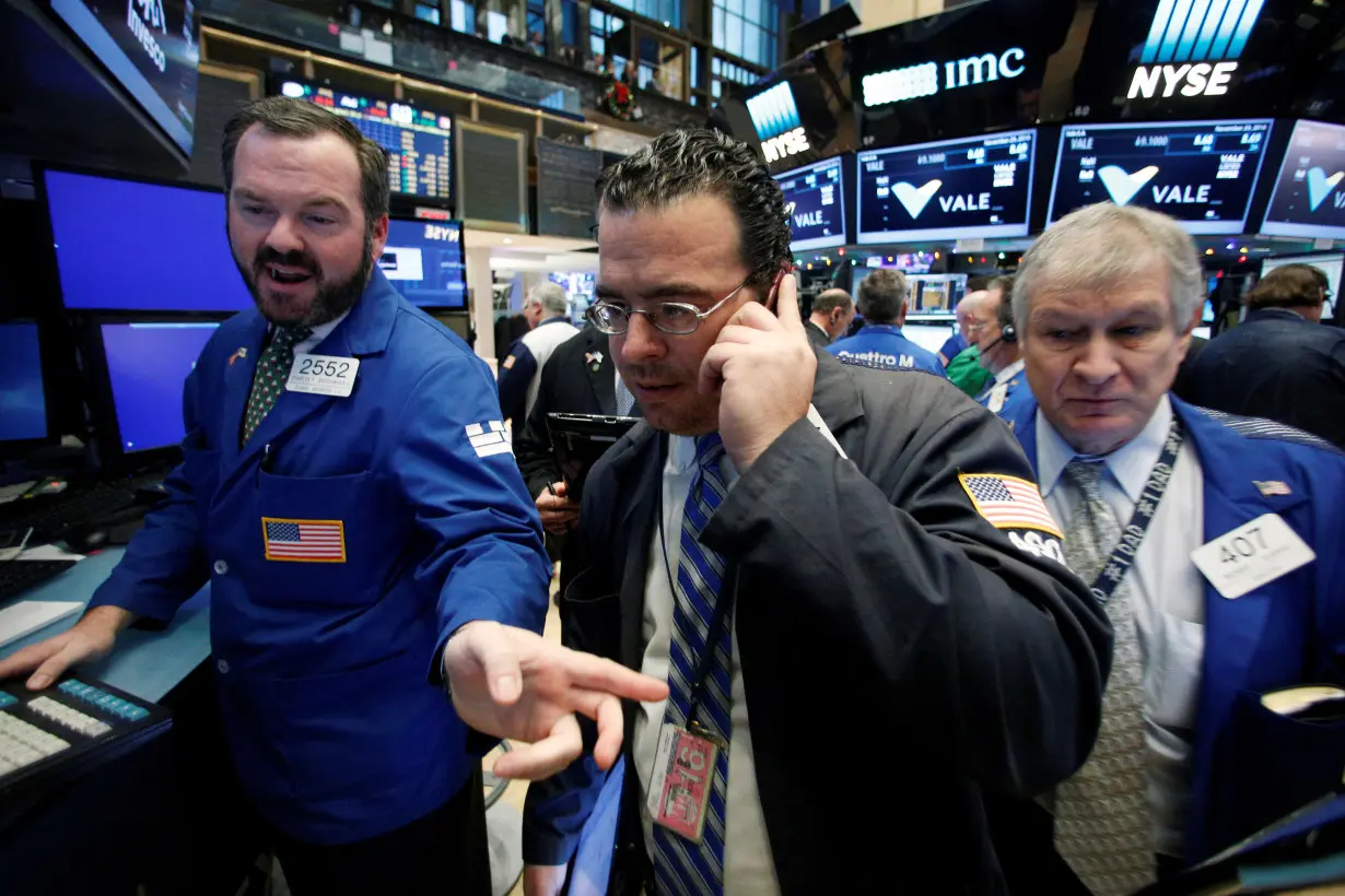 Traders work on the floor of the NYSE