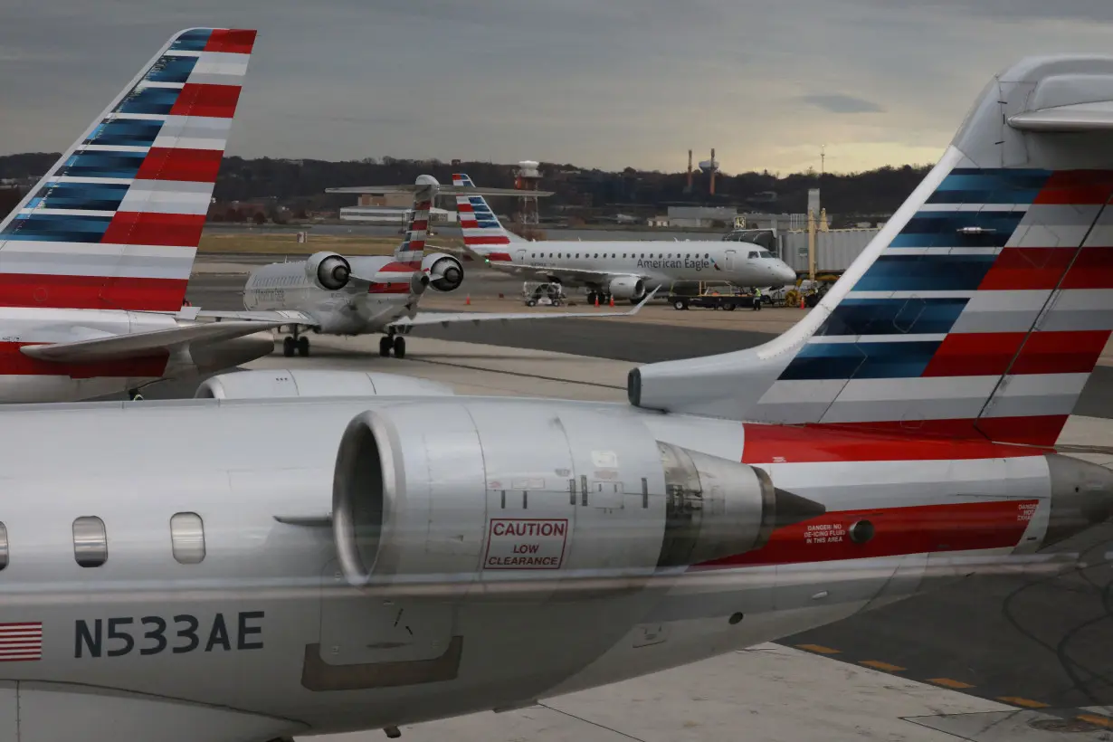 FILE PHOTO: A jet from American Eagle, a regional branch of American Airlines (AA), taxis past other AA aircraft at Ronald Reagan Washington National Airport in Arlington