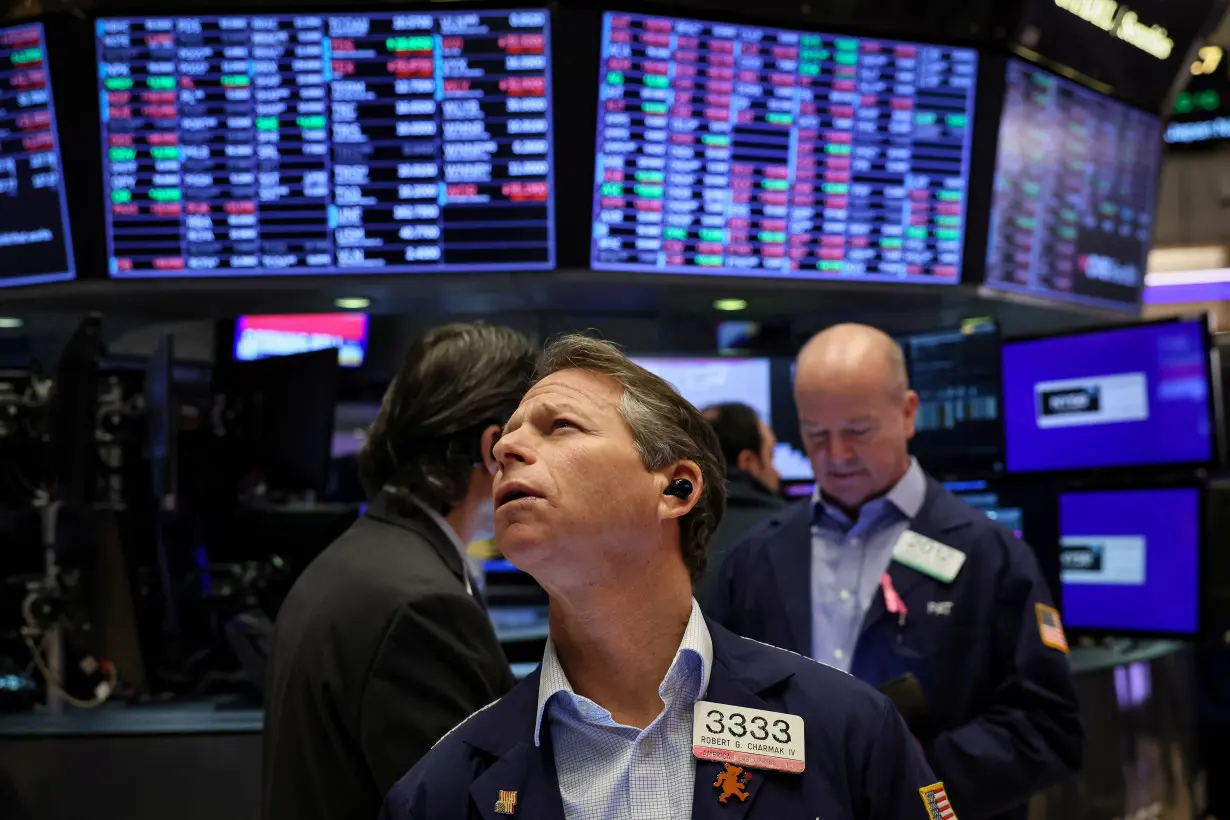 Traders work on the floor of the NYSE in New York