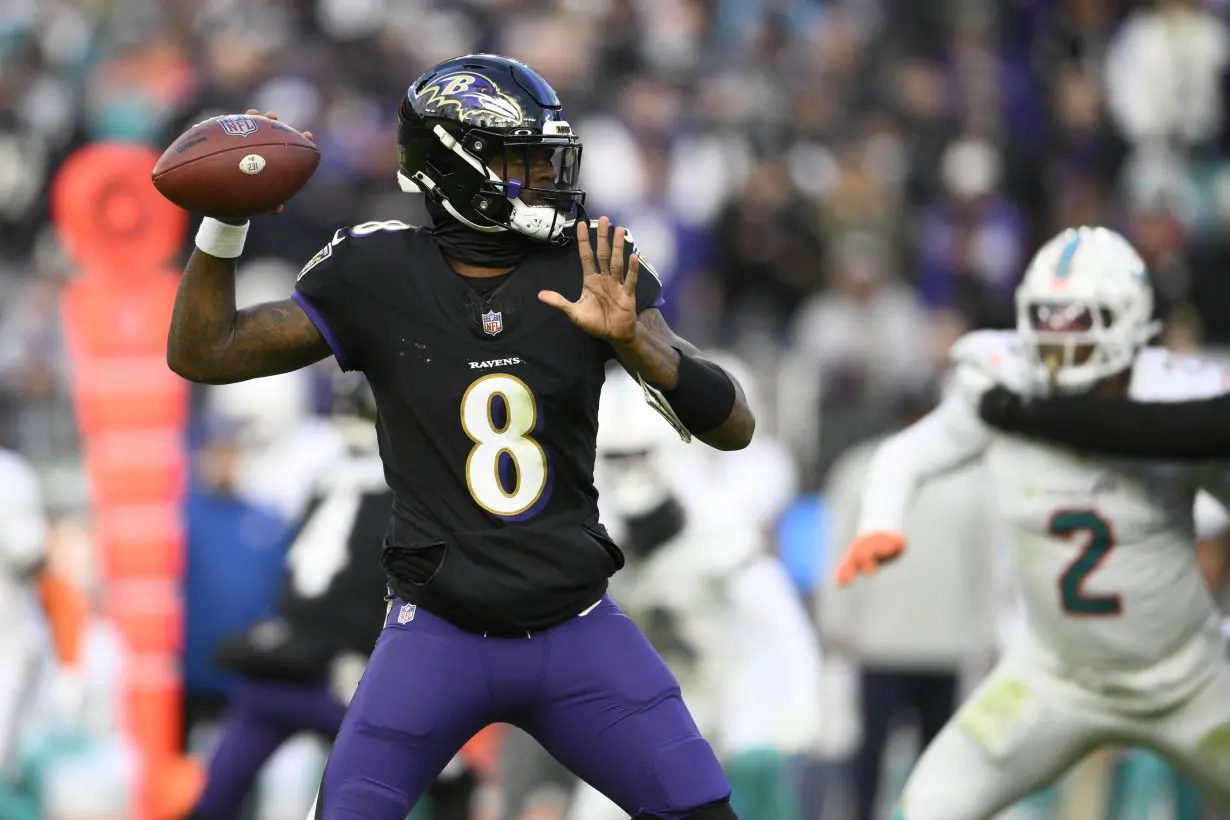 Lamar Jackson's perfect passer rating helps Ravens rout Dolphins 56-19 to clinch top seed in AFC