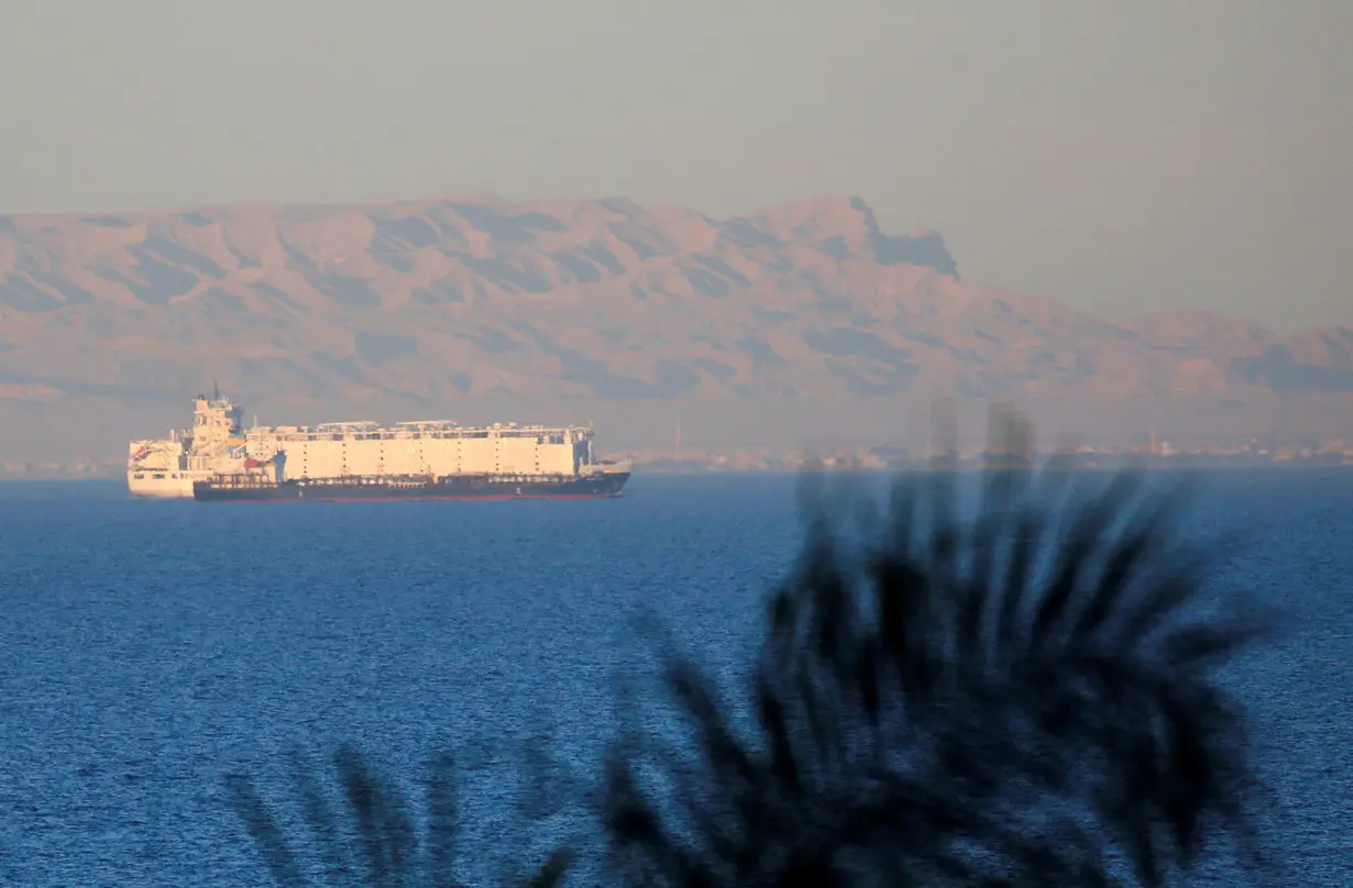 FILE PHOTO: Container ships sail across the Gulf of Suez towards the Red Sea before entering the Suez Canal, in El Ain El Sokhna in Suez