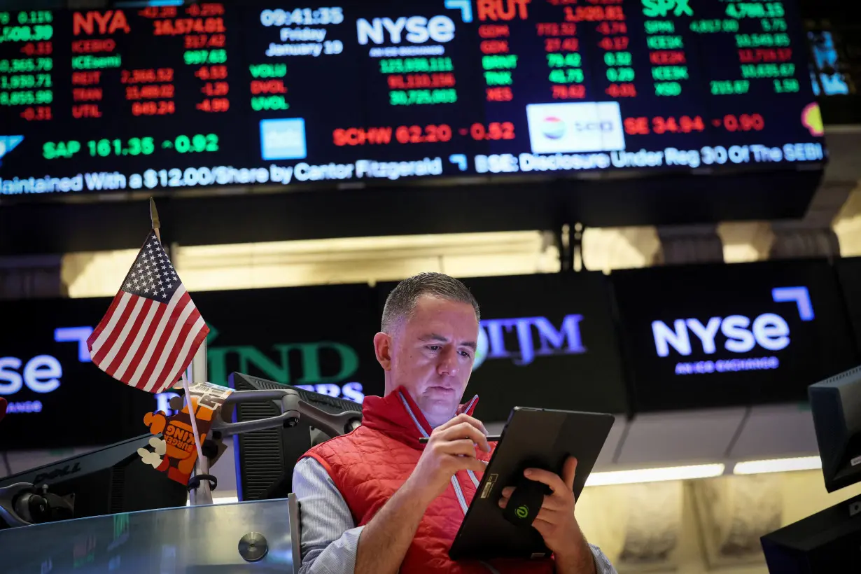 Traders work on the floor of the NYSE in New York