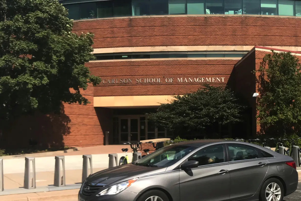 FILE PHOTO: A car drives past the Carlson School of Management at the University of Minnesota in Minneapolis Minnesota