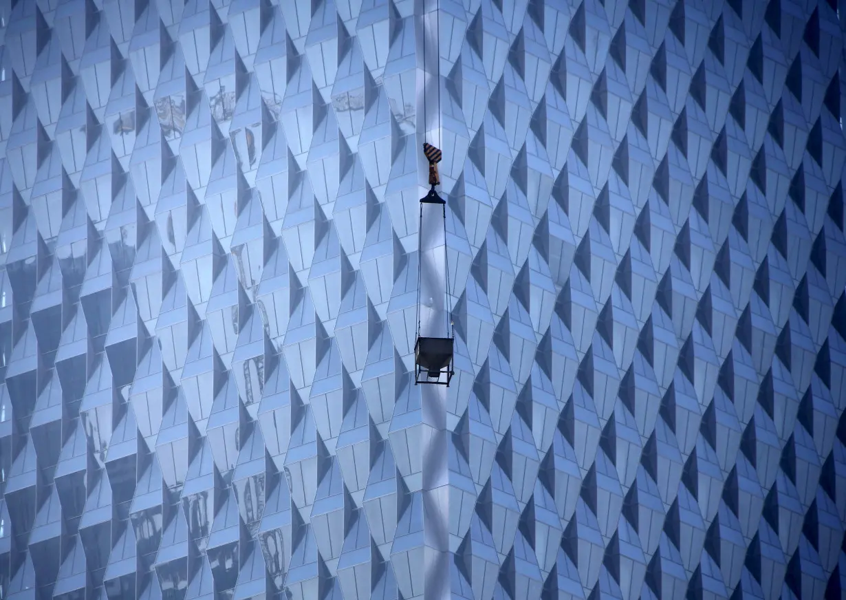 A crane is seen at a construction site for a new commercial building in Beijing