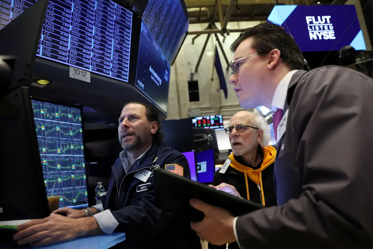 Traders work on the floor of the NYSE in New York