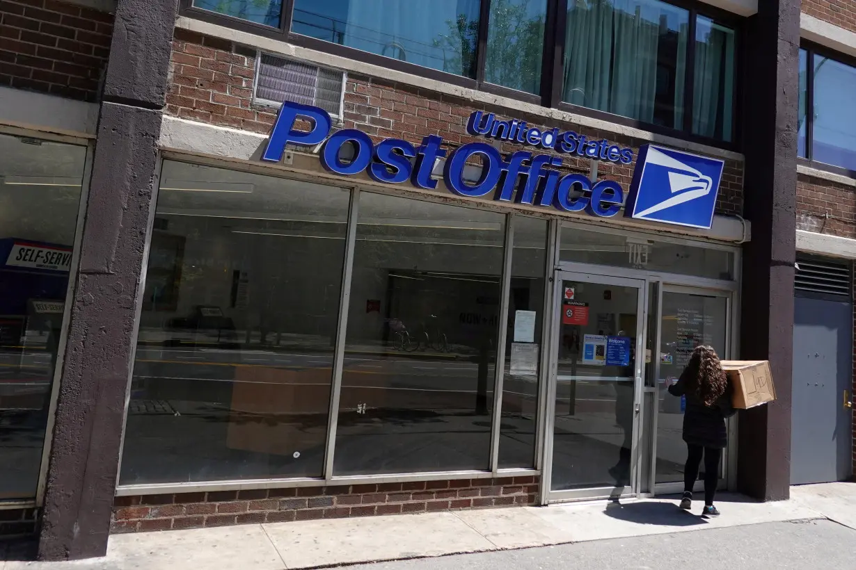 FILE PHOTO: A person enters a United States Postal Service Post Office in Manhattan, New York City