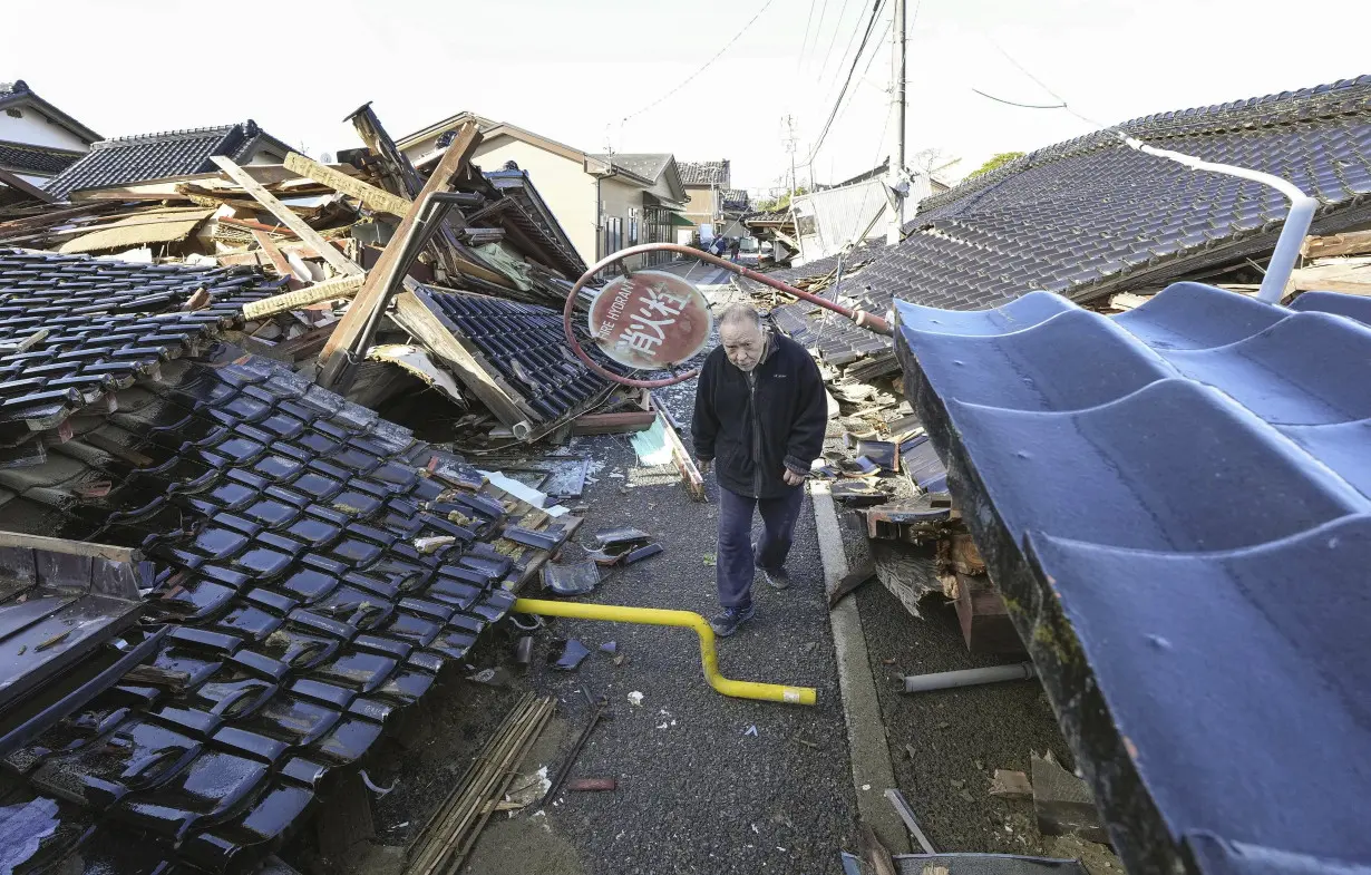 Rescuers race against time in search for survivors in Japan after powerful quakes leave 78 dead