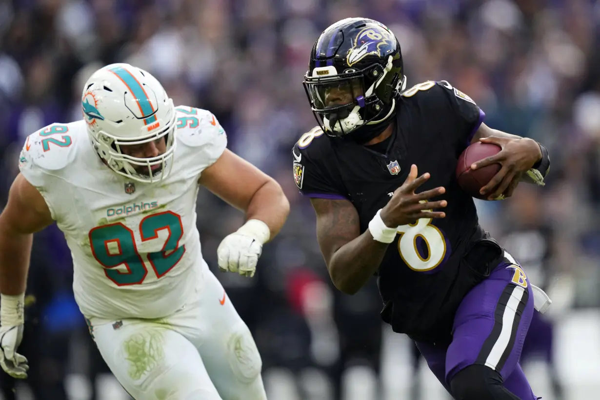 Lamar Jackson's perfect passer rating helps Ravens rout Dolphins 56-19 to clinch top seed in AFC