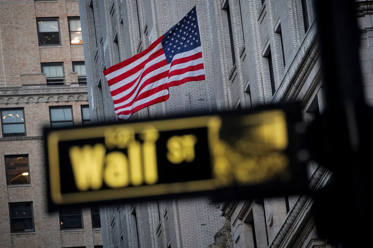 FILE PHOTO: The U.S. flag is seen on a building on Wall St. in the financial district in New York