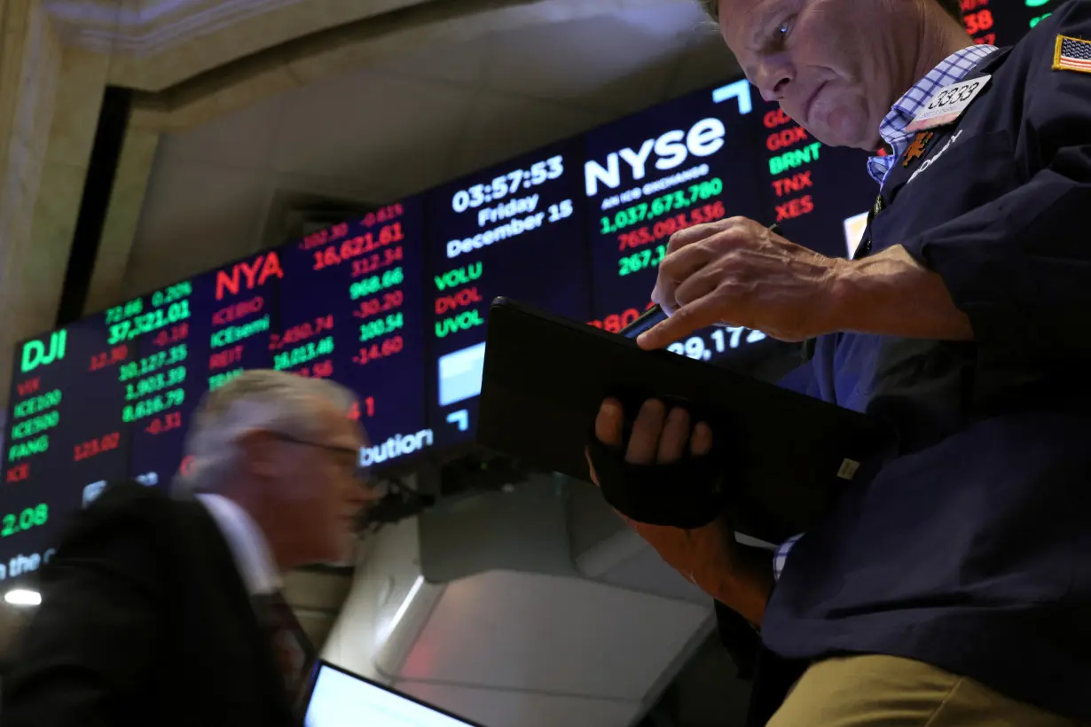 FILE PHOTO: Traders work on the floor of the NYSE in New York