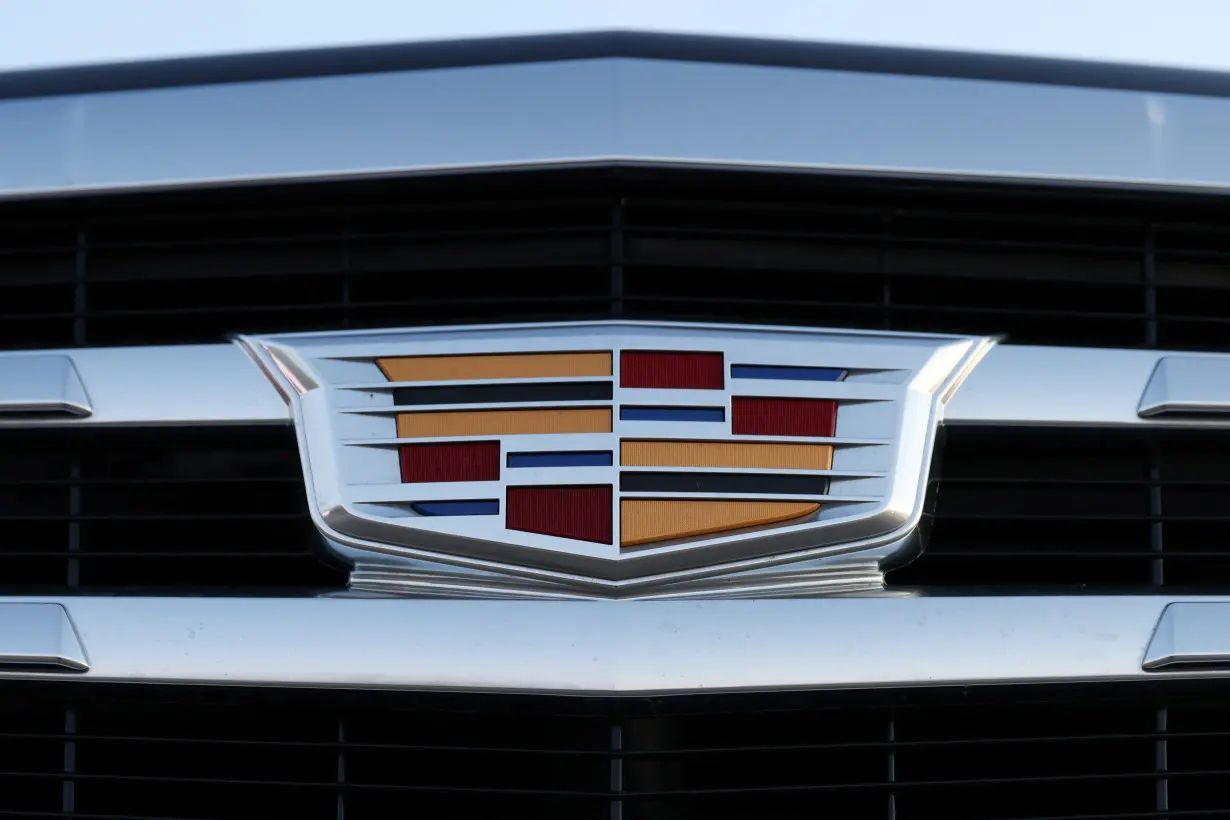 A badge of Cadillac, an automobile brand owned by General Motors Company, is seen on the grill of a vehicle for sale at a car dealership in Queens, New York