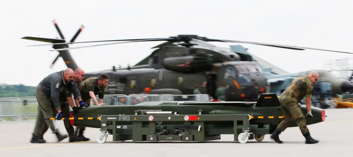 FILE PHOTO: German soldiers move a dummy Taurus bomb during preparations for the upcoming ILA Berlin Air Show in Schoenefeld