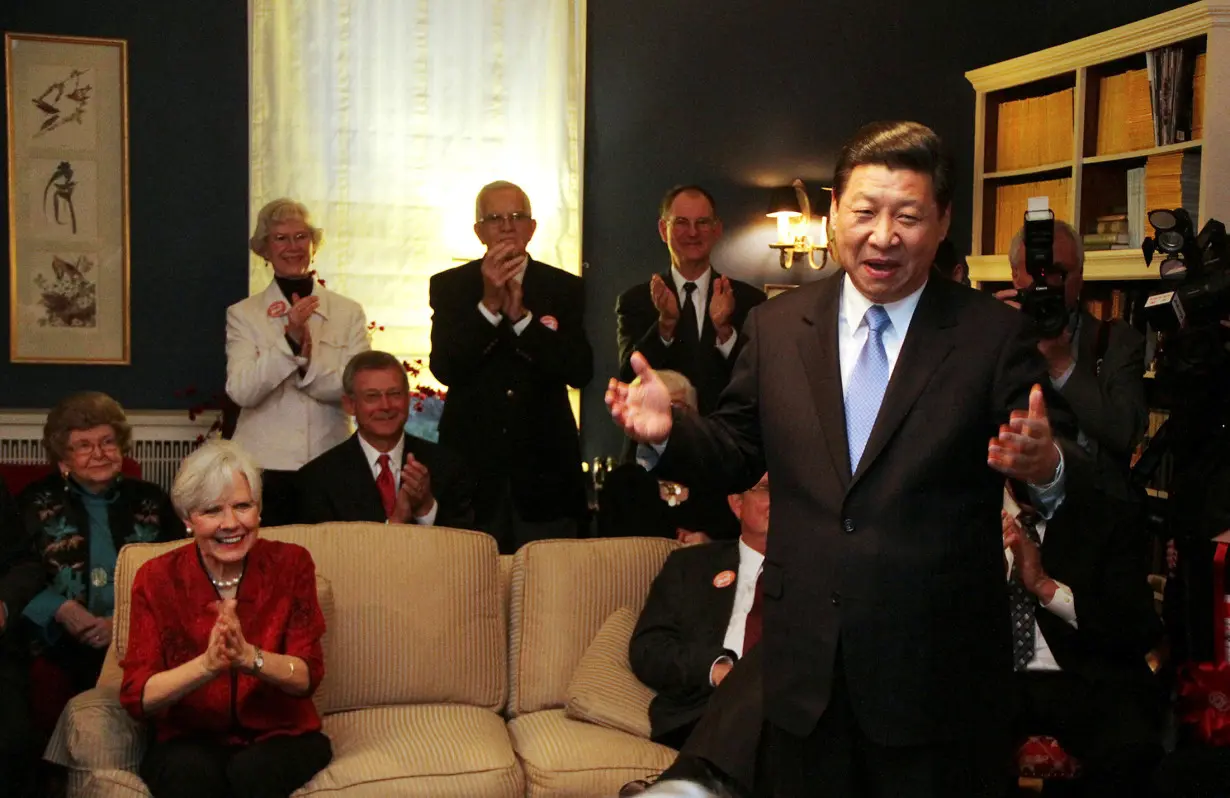 FILE PHOTO: China's Vice President Xi Jinping speaks at the home of Roger and Sarah Lande (2nd L) in Muscatine