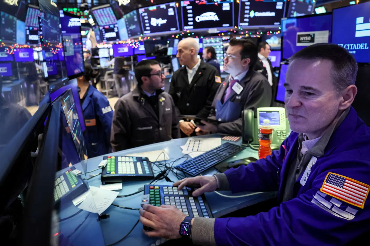 Traders work on the floor of the NYSE in New York